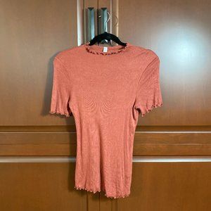 ribbed orange mock neck t-shirt with ruffle edges